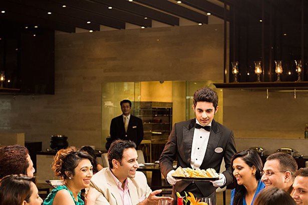 Server presenting a dish at a corporate dinner