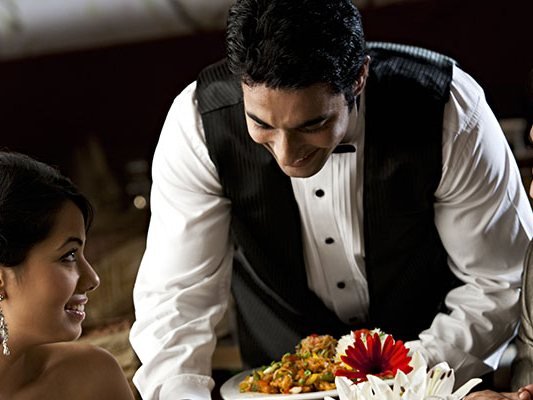 Dish being served to guests at the table